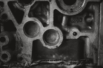 A close up of a metal piece with the letters V and W on it