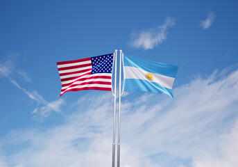 flags of  argentina and United States of America over blue sky background.