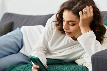Relaxing at home while scrolling through the phone on a cozy afternoon