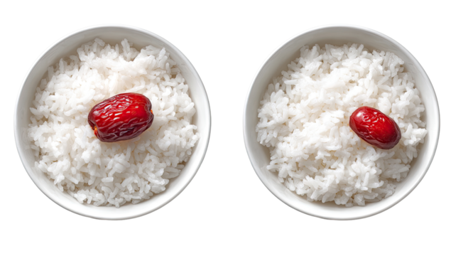 Two white bowls of cooked rice, each topped with a red date