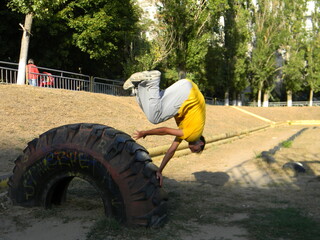 A guy does an acrobatic Palm Spin stunt in parkour style.	
