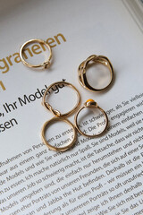 jewelry on a simple background, jewelry aesthetics, jewelry flatlay, gold ring, pearl earrings