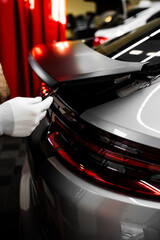 Vinyl Application in Progress in detailing. Vinyl film is trimmed with sharp blade to ensure...
