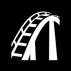 Rollercoaster structure ascends dramatically against stark backdrop showing ride element design detail