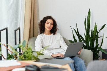 Young woman enjoys remote work in a cozy home office with greenery