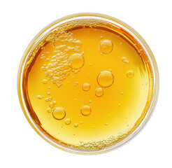 Overhead view of a glass filled with golden bubbly liquid against transparent background