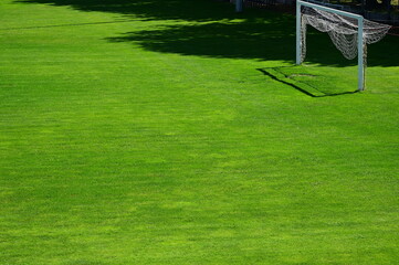 out of use soccer and sport field. goal post with raised net. symbolizing out of use for summer maintenance and service. lock down sport facility. bright green turf and grass. sport concept.