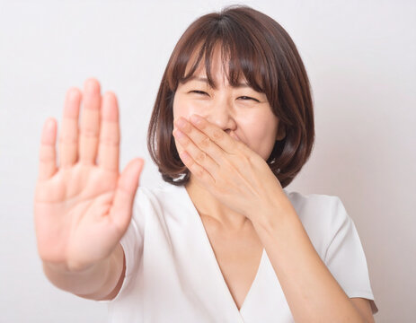 Woman Stopping Bad Odor with Hand 中年女性が照れながら手を出して止める