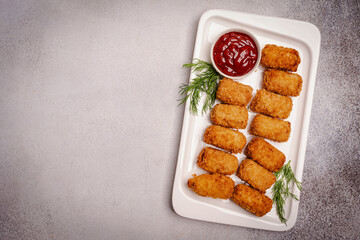 Delicious Potato Croquettes - mashed potatoes balls with grated mozzarella cheese seasoned with spices, breaded and deep fried in olive oil, served with sauce, view from above