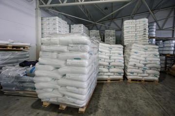 White polyethylene bags with factory products in warehouse