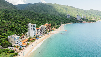 Puerto vallarta beachfront hotels nestled between lush tropical rainforest and turquoise ocean