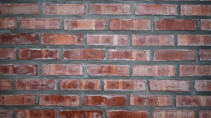 The wall is made of bricks, looks very artistic, used to decorate the house.