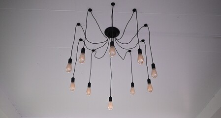 A very beautiful classic chandelier on a white wall, used for home decoration