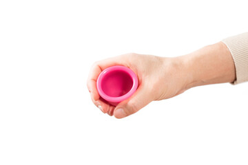 in female hands pink menstrual cup. pink menstrual cup on light background. close-up of hand with...