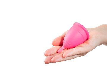 in female hands pink menstrual cup. pink menstrual cup on light background. close-up of hand with menstrual cup. Zero waste concept. Alternative feminine hygiene product