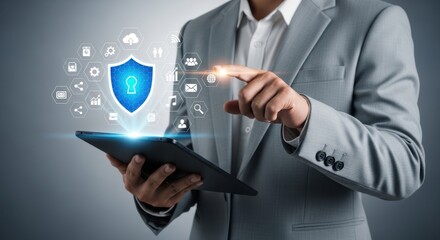 Naklejka premium A businessman in a suit uses a tablet with a glowing digital shield and interconnected icons representing data security and