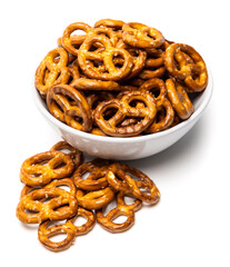 Small traditional beer pretzels with salt in a white ceramic bowl isolated on white background