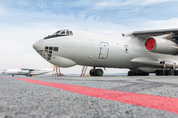 Two white wide body freight transport airplanes at airport