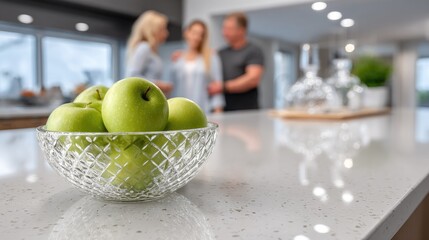 Family members gather around the kitchen counter, smiling and interacting while preparing green apples on a bright, sunny day