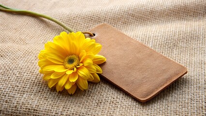 Yellow Flower on Dark Leather Tag on Beige Fabric