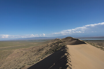 Footprints along singing dune ridge, Kazakhstan
