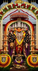 Beautiful hindu deity goddess statue decorated with flowers in temple for religious worship