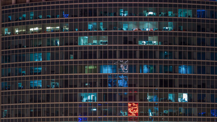 Close up view to office windows in Skyscrapers of City at night timelapse from top