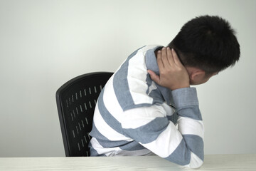 Man having tensed muscles fatigued, neck, shoulder, back, wrist and arm pain during work long time...