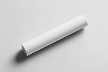 Top-down view of a single blank white A3 poster rolled into a horizontal cylinder, placed diagonally on a smooth light gray surface
