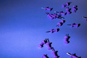 Scattered purple push pins on a cool blue surface. Soft shadows and clean contrast evoke calm productivity. Great for planners, office blogs, or educational content.