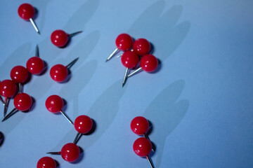 Bright red pushpins scattered on a cool blue background evoke focus, urgency, and creative planning — perfect for blogs, office ads, school content, or productivity themes.