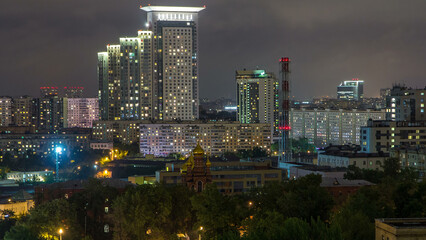 Fototapeta premium Night Moscow cityscape from rooftop timelapse. Residential buildings at night. Night view from the roof