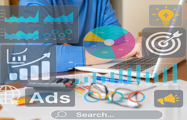Businesswoman is working with laptop and digital marketing ads and analytics interface showing pie...