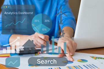 Businesswoman analyzing financial charts and company performance on an analytics dashboard,...