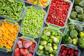 Assortment of frozen vegetables in plastic boxes. Preparing food for the winter.