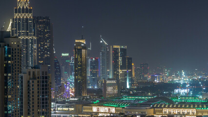 Aerial cityscape timelapse at night with illuminated modern architecture in Downtown of Dubai, United Arab Emirates.