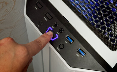 Finger about to press a power button. Hardware equipment concept. Composite between an image