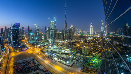 Dubai Downtown day to night timelapse. Aerial view over big futuristic city by night.