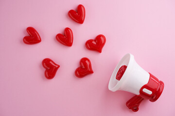 Valentine's Day background of megaphone and heart shaped  on pink background.