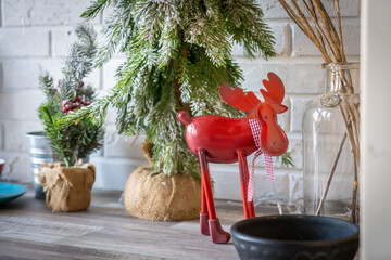 Christmas card conception. Christmas toy deer decoration with christmas tree branch and snow