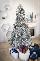 Luxury interior of living room with decorated Christmas tree and gifts on the wooden floor.