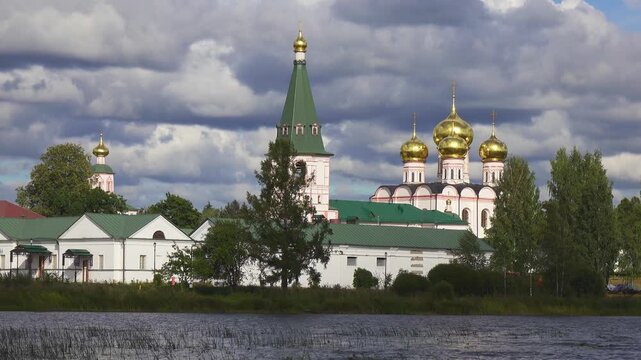 View from the water at Valdai Iversky Svyatoozersky Virgin Monastery for Men. Selvitsky Island, Valdai Lake. View of the Valdai Iversky Bogoroditsky svyatoozersky monastery. Sunny June day,