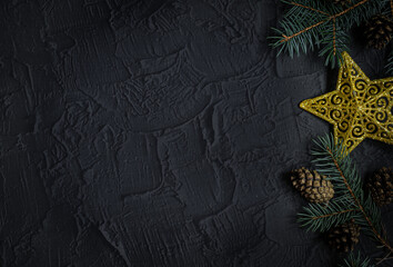 Christmas background with fir tree and decor on dark background. Top view with copy space