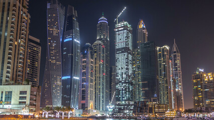 Obraz premium Dubai marina bay with yachts an boats night timelapse