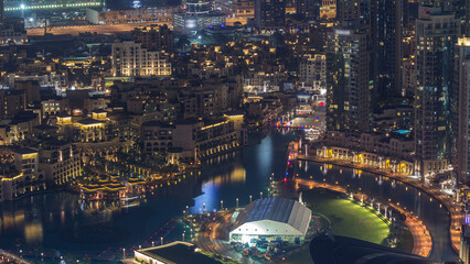 Fototapeta premium Dubai Downtown night timelapse modern towers panoramic view from the top in Dubai, United Arab Emirates.
