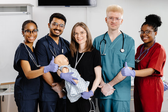 Paramedics practicing cpr on dummy during medical training