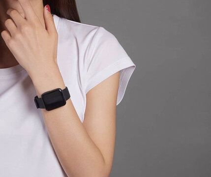 The girl shows the smartwatch on his hand
