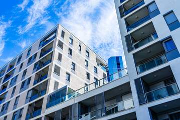 Modern Multi-Story Residential Building with Vibrant Facade, Large Balconies, and Scenic Urban...