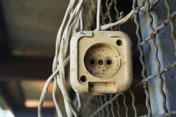 an old electrical outlet, an extension cord, which imagined itself to be the highest element of...