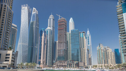 Fototapeta premium Panoramic view with modern skyscrapers and yachts of Dubai Marina timelapse, United Arab Emirates